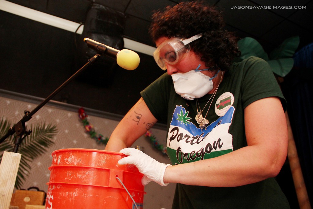 Joy mixes the hemp shiv, lime and water together until it is all moist.